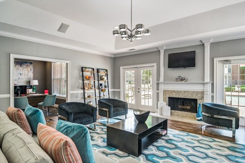 a living room with couches and chairs and a fireplace